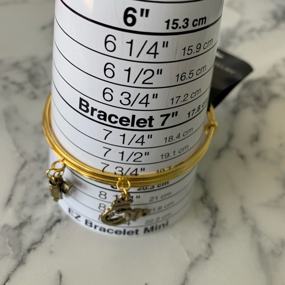 Gold Charm Bangle Bracelet with gun, bullet and handcuff charms. - Picture 3 of 3